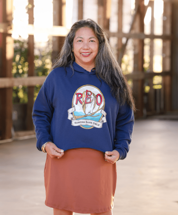 Woman Wearing Cropped Hoodie with Red Owl Logo in Navy